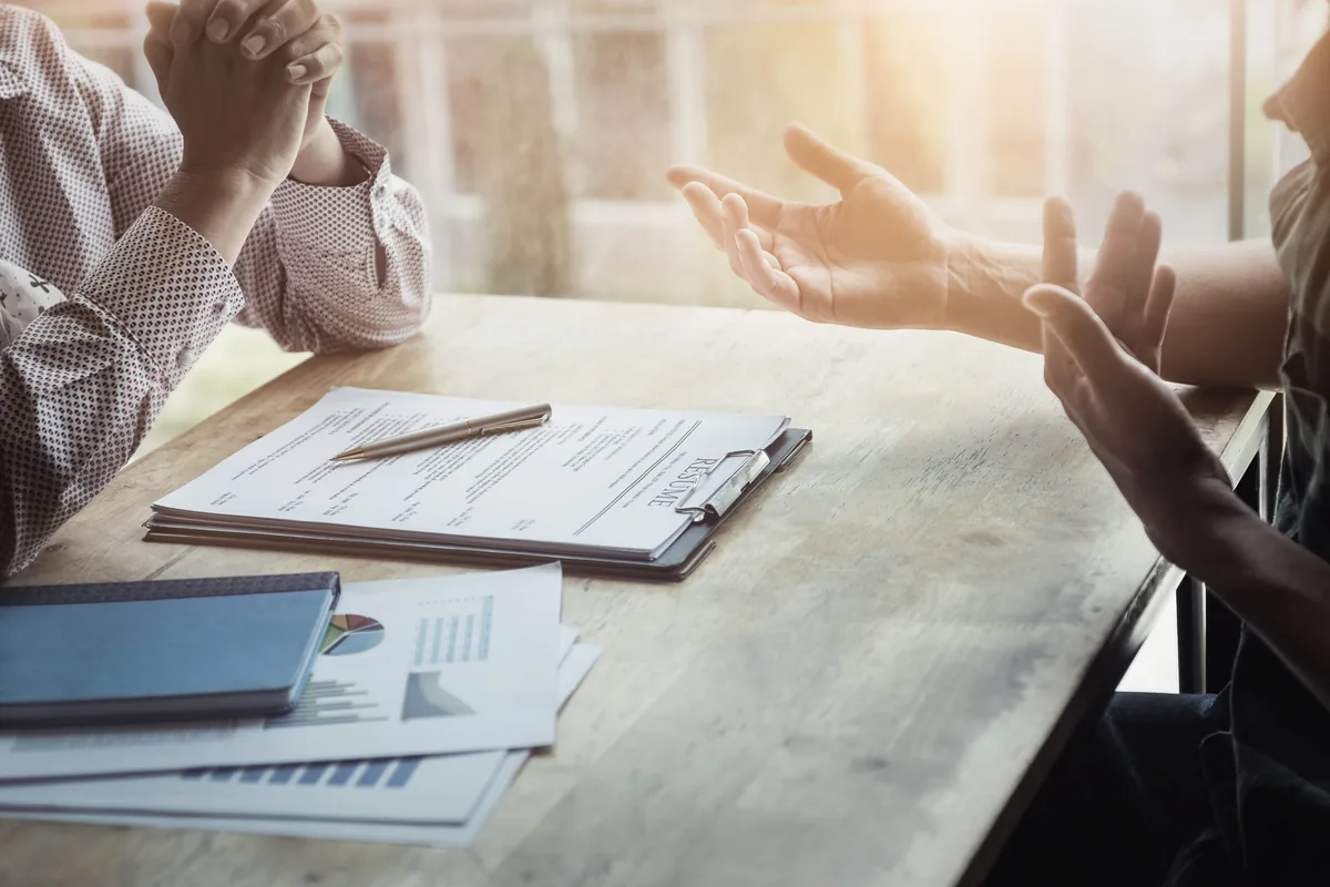 Candidate interviewing a recruiter across a desk