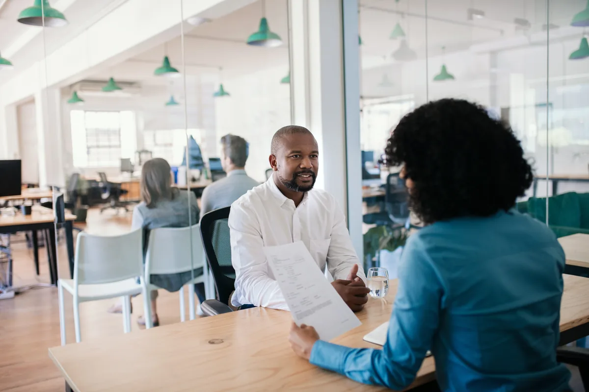 Hiring manager evaluating a candidate across a table