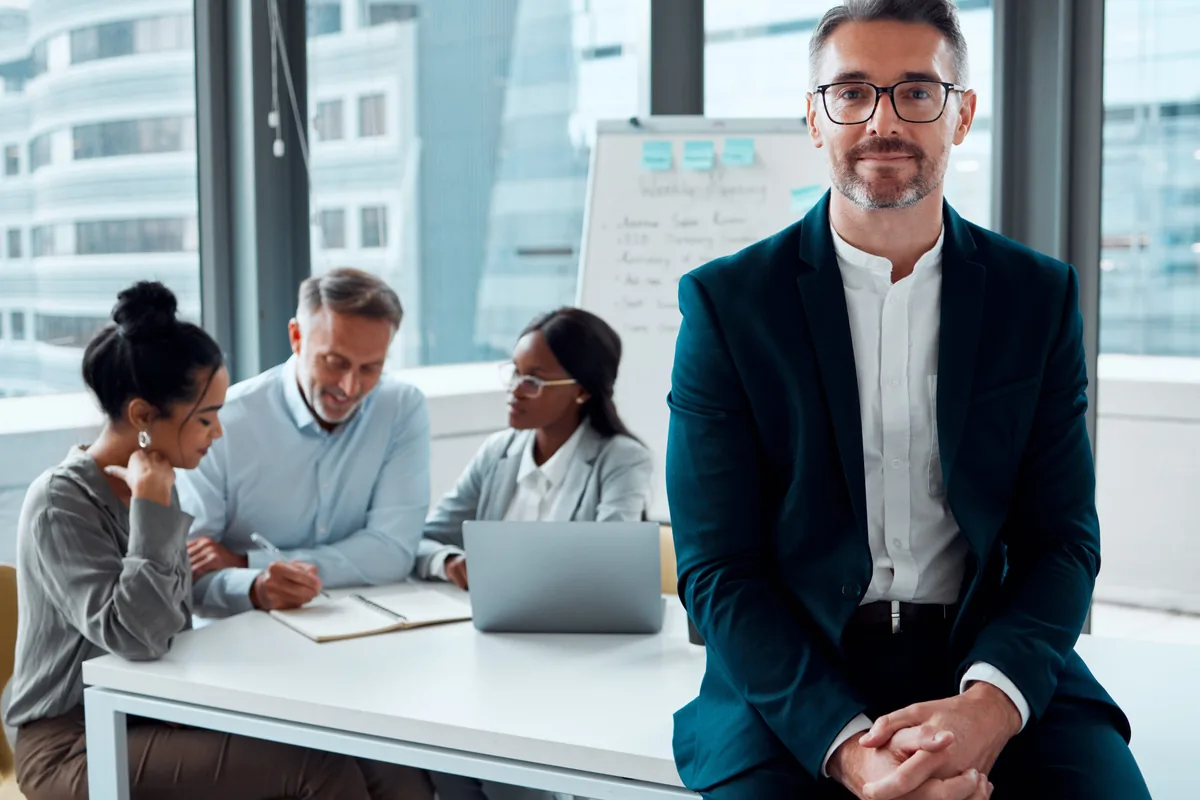Executive leading a compensation discussion with a leadership team